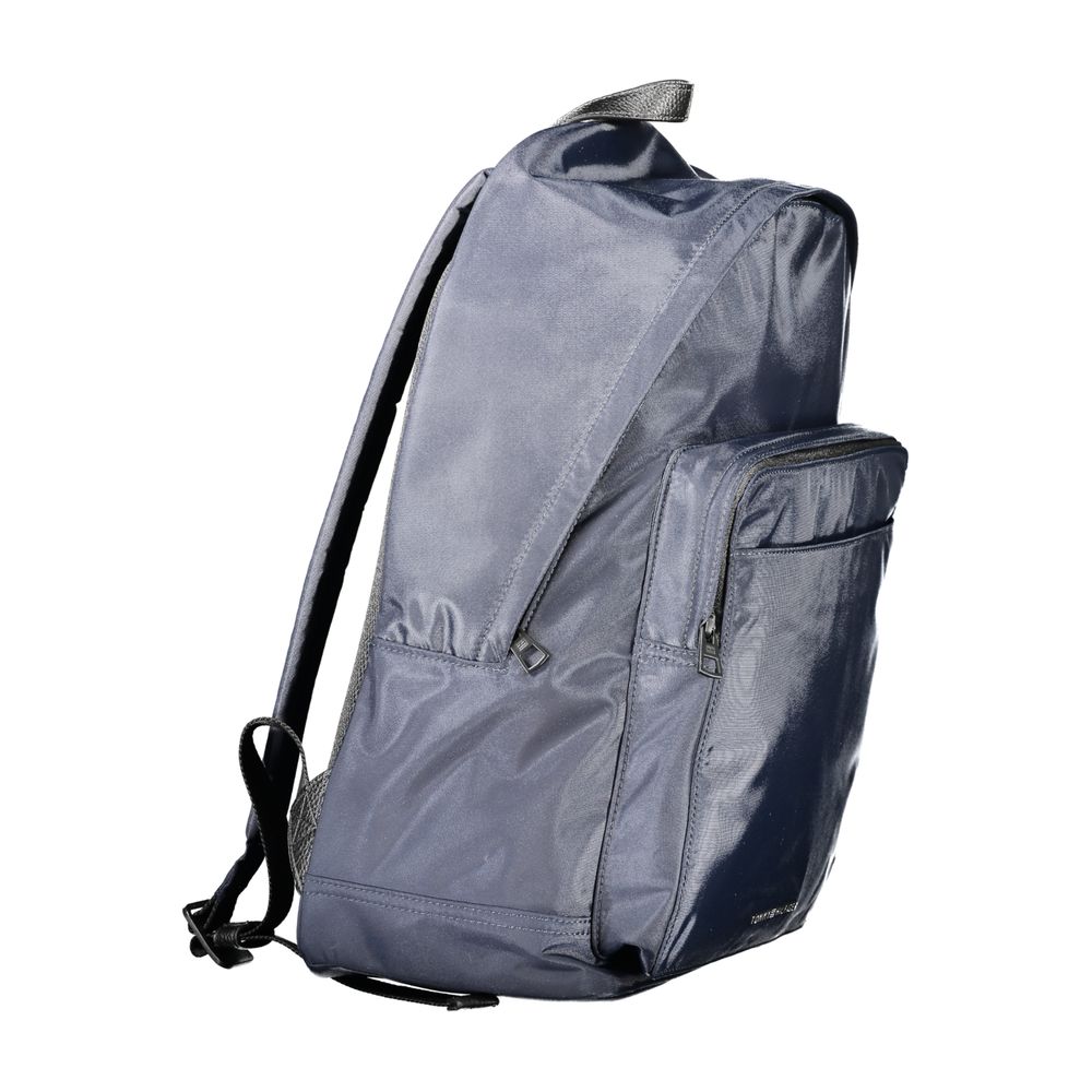 Side view of Tommy Hilfiger Blue Polyester Backpack with adjustable straps, external pockets, laptop compartment, and logo detailing.