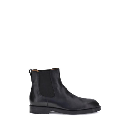 Side view of Tod's Black Calf Leather Bos Taurus Chelsea Boots with elastic side inserts and back tab for comfort. Made in Italy.