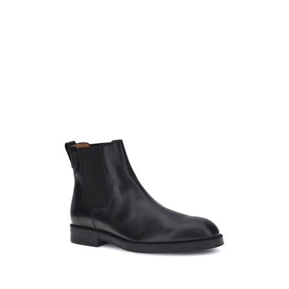 Tod's Black Calf Leather Bos Taurus Chelsea Boots with elastic side inserts and back tab for comfort.