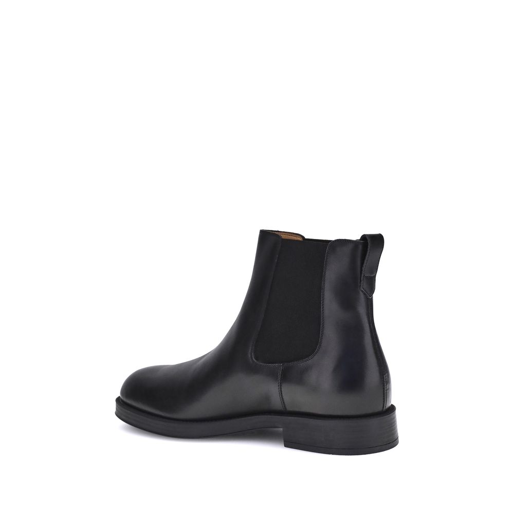 Alt Tag: Side view of Tod's Black Calf Leather Bos Taurus Chelsea Boots with elastic side inserts.