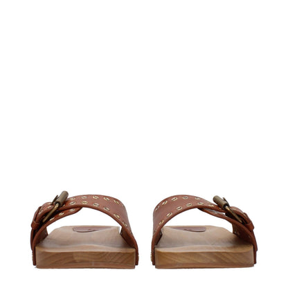 Isabel Marant Brown Leather Slippers with buckle closure, open toe, and low flat heel. Rubber sole, casual style, cognac accents.