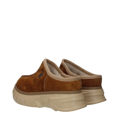 Givenchy Brown Leather Slippers with suede material, round toe, rubber sole, and side logo. Casual style with mid heels, back logo visible.
