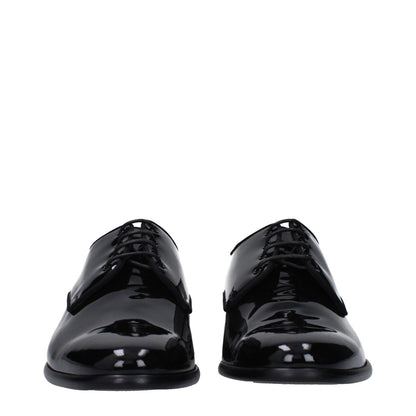 Dolce & Gabbana Black Leather Oxfords And Derbies with lace-up style and pointy toe, featuring a low flat heel and patent finish.