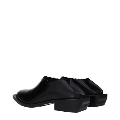 Moschino Black Leather Mules with rubber sole, pointy toe, and mid heel of 3.5 cm, style MA10514M0LMD5000, casual loafers design.