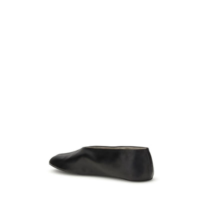 The Row Black Lamb Ovis Aries Aries Ballet Flats side view, showcasing sleek silhouette and tapered toe in black nappa leather.
