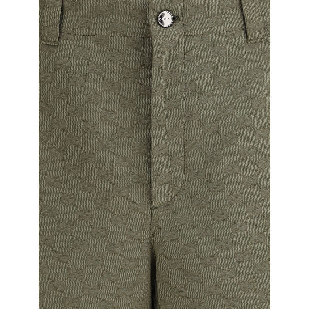 Close-up of Gucci Green Cotton Bermuda Shorts with GG pattern, front zipper, and button closure, showcasing the iconic monogram design.