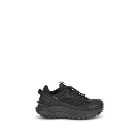 Moncler Black Calf Leather Bos Taurus Athletic Sneakers with reflective inserts and logo, side view on white background.
