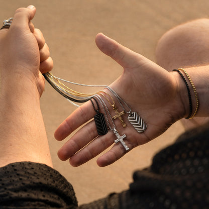 Alt Tag: Person holding various necklaces featuring pendants from AN JEWELS JEWELRY Mod. AA.C256PBK.