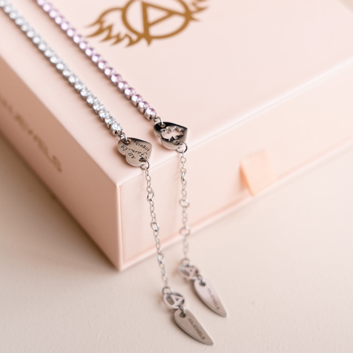 AN JEWELS JEWELRY Mod. AL.BLIYMPK necklace displayed on a pink box with elegant pendant details.