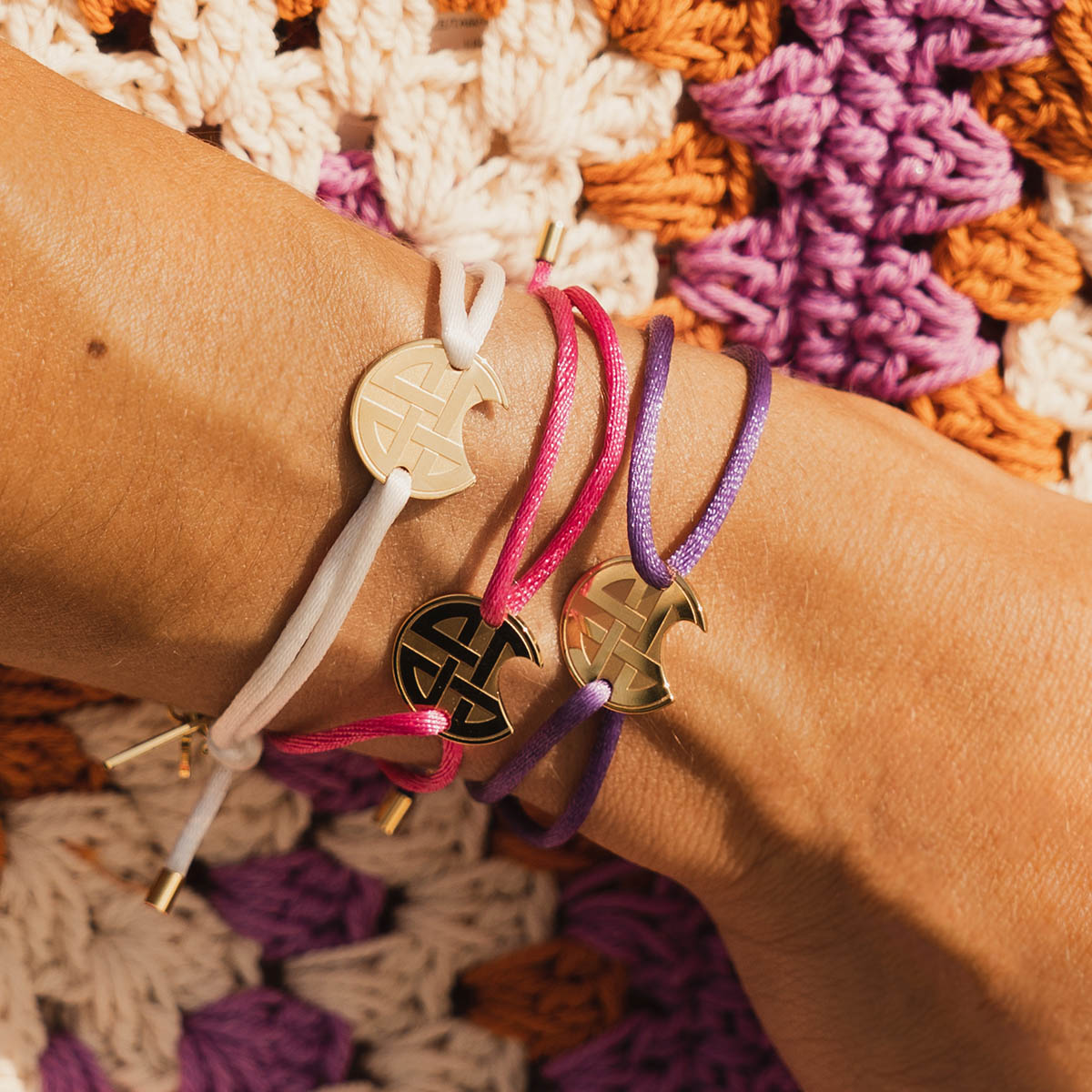 Three AN JEWELS JEWELRY Mod. AV.BGLBGGPK bracelets on wrist with colorful background