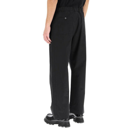 Back view of Alexander McQueen Black Cotton Casual Pants with elastic waist and pockets, detailed stitching, made in Italy.