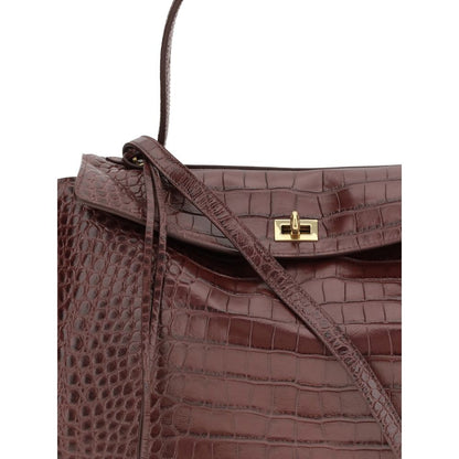 Close-up of Balenciaga Brown Calf Leather Bos Taurus Handbag showcasing crocodile-effect design and gold flap closure.