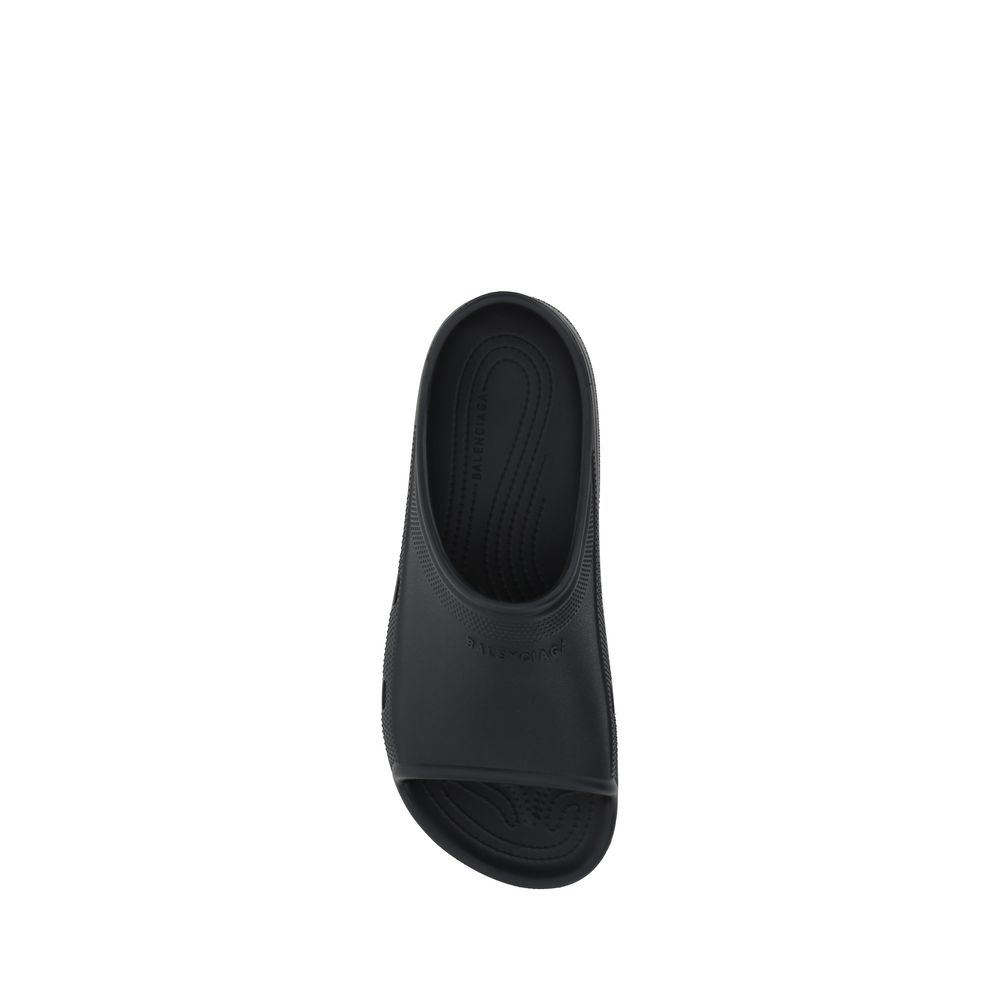 Alt Tag: Top view of black Balenciaga Eva Sandals featuring unique rubber design, open toe, and embossed logo on front strap, SS25 collection.