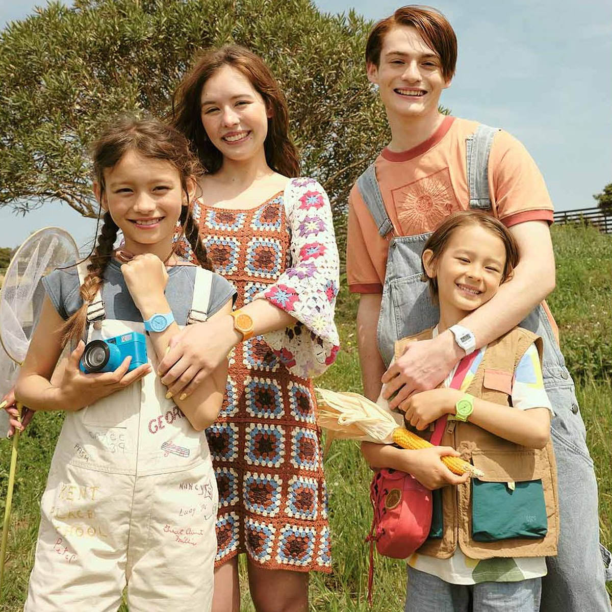 Family enjoying outdoor day in summer attire, children holding camera and straw hat. Watches from CASIO TIMELESS COLLECTION Mod. POP featured.