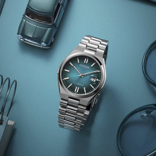 CITIZEN WATCHES Mod. NJ0151-88X on stainless steel band with blue dial displayed on a blue background, stylish and modern design.