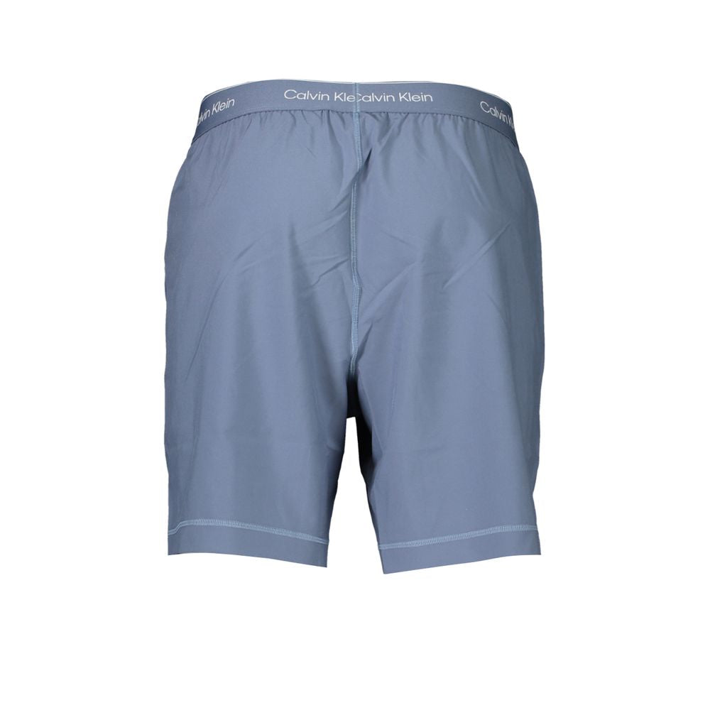 Calvin Klein Blue Polyester Pant, sports short with elastic waist, breathable fabric, two pockets, and logo print detail.