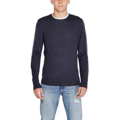Man wearing Calvin Klein Blue Recycled Wool Sweatshirt with ribbed finishes on collar, cuffs, and hem for a modern look.