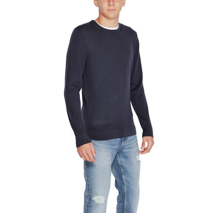Model wearing Calvin Klein Blue Recycled Wool Sweatshirt with crew neck and ribbed finishes.