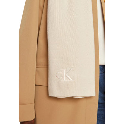 Calvin Klein Cream Recycled Polyester Scarf with embroidered monogram, shown on a stylish beige coat.