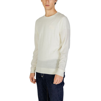 Model wearing Calvin Klein Cream Recycled Wool Sweatshirt with crew neck, ribbed finishes, and regular fit