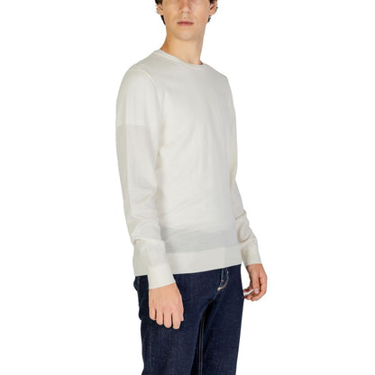 Model wearing Calvin Klein Cream Recycled Wool Sweatshirt with crew neck and ribbed finishes, offering sustainable and stylish knitwear.