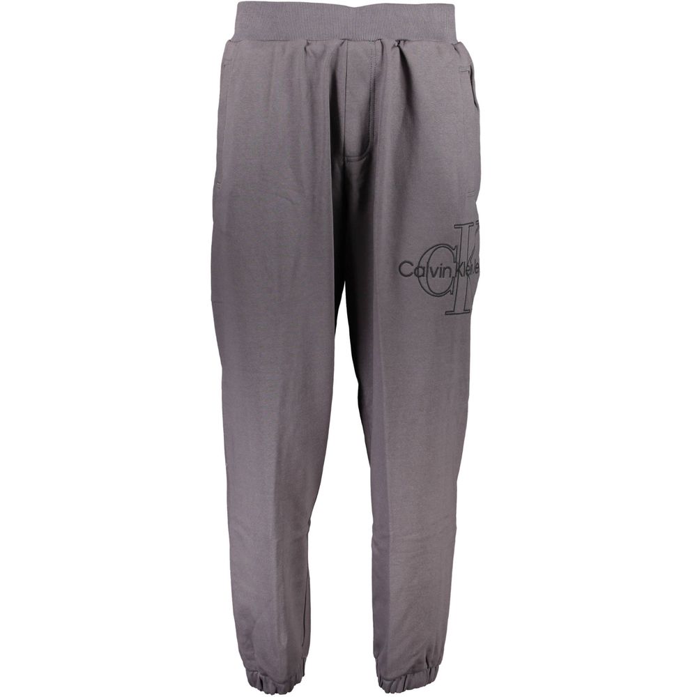 Calvin Klein Gray Cotton Pant featuring elastic waist, ankle cuffs, embroidery, and logo design. Made of 50% transitional cotton.