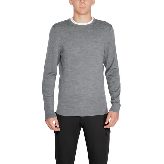 Man wearing Calvin Klein Gray Recycled Wool Sweatshirt with crew neck design and ribbed finishes, made from 100% recycled wool.