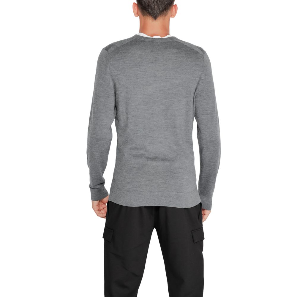 Back view of man wearing Calvin Klein Gray Recycled Wool Sweatshirt, showcasing classic design and sustainable materials.