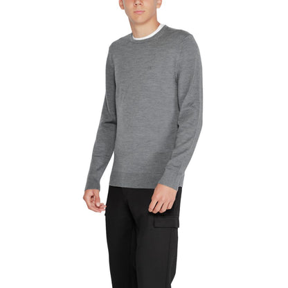 Model wearing Calvin Klein Gray Recycled Wool Sweatshirt with crew neck and ribbed finishes, showcasing sustainable fashion.