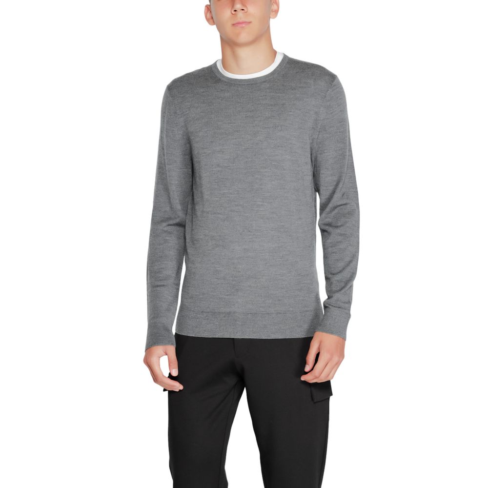 Model wearing Calvin Klein Gray Recycled Wool Sweatshirt featuring crew neck and ribbed finishes, made from sustainable materials.