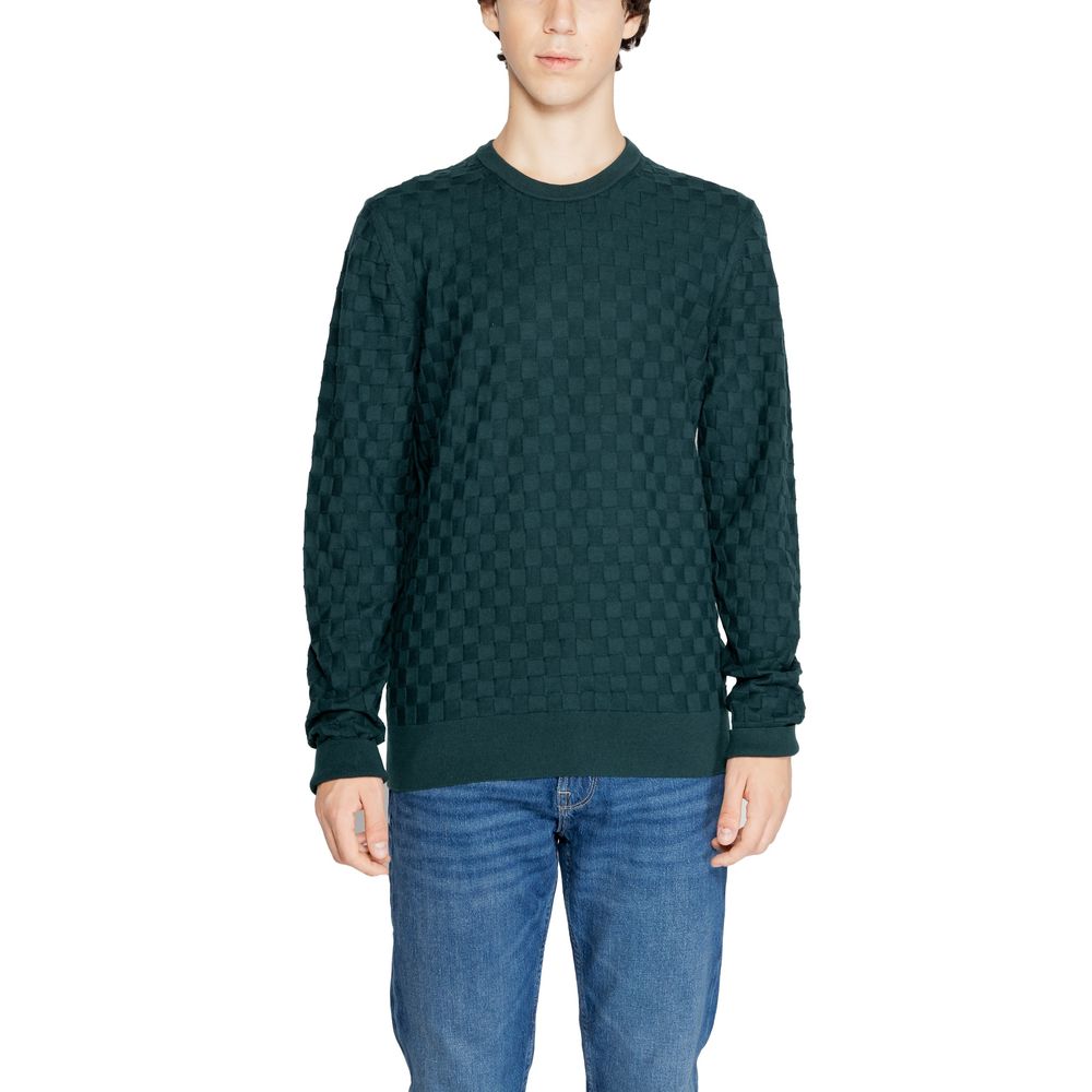 Calvin Klein Green Organic Cotton Sweatshirt with basket weave pattern, worn by a male model in blue jeans, front view.