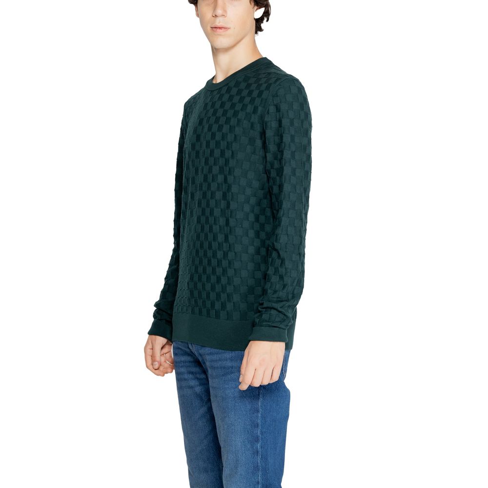 Model wearing Calvin Klein Green Organic Cotton Sweatshirt with basket weave pattern, showcasing sustainable fashion and contemporary style.