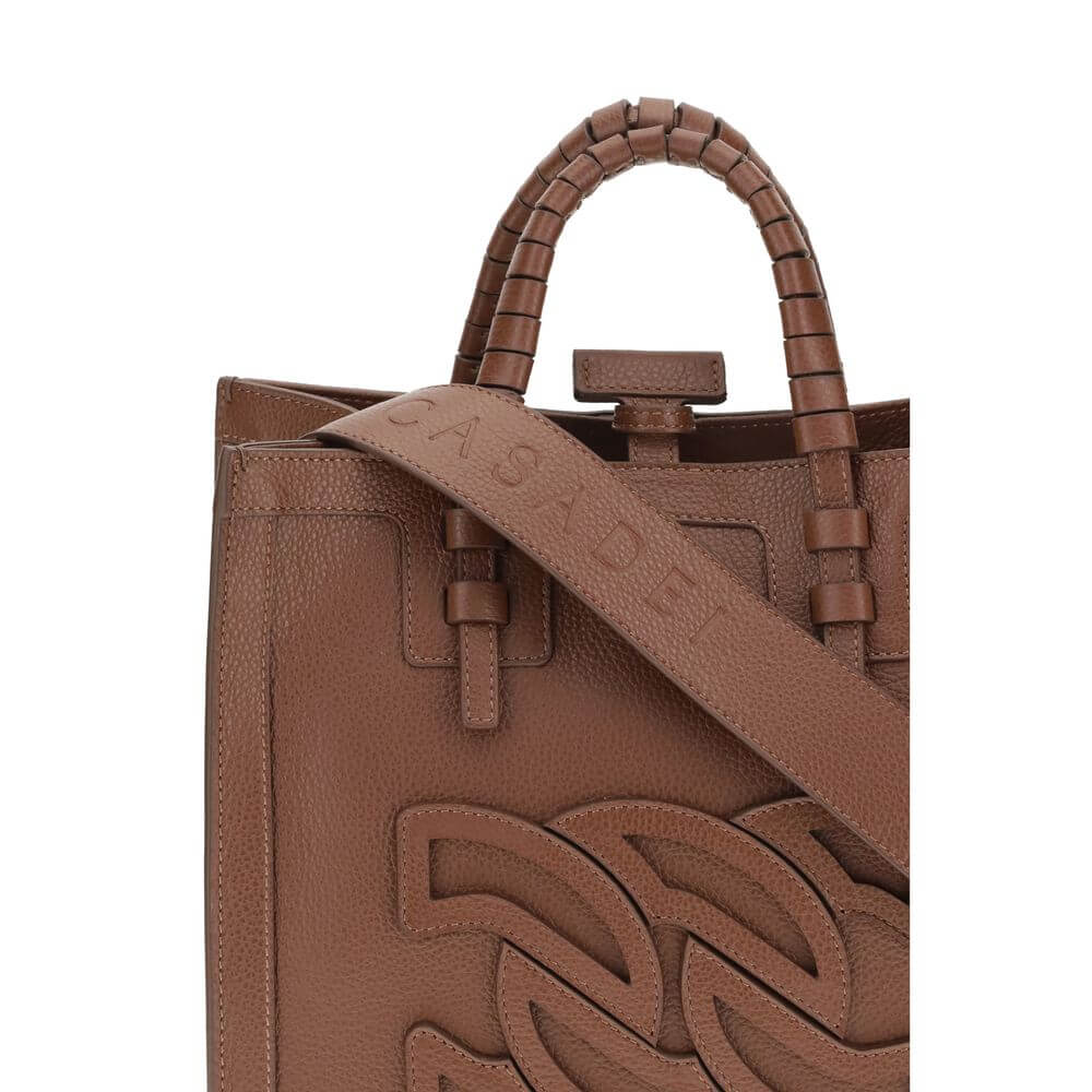 Close-up of Casadei Brown Calf Leather Bos Taurus Shoulder Bag with embossed logo, tubular handles, and adjustable strap.
