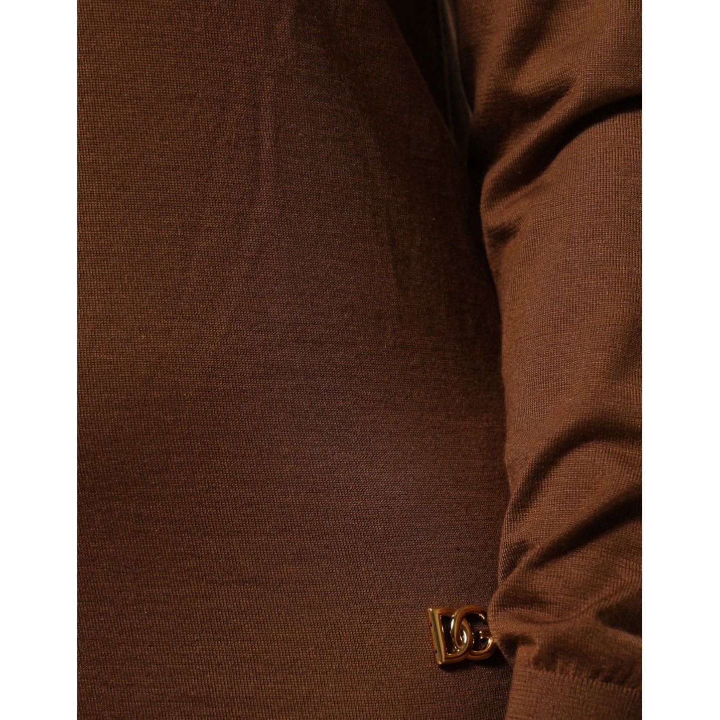 Close-up of Dolce & Gabbana Brown Cashmere Turtle Neck Pullover Sweater fabric and logo detail.