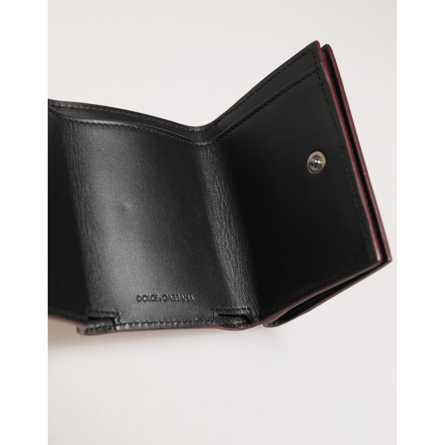 Open view of Dolce & Gabbana Red Leather Bold Logo Print Trifold Card Holder Wallet interior, showcasing high-quality craftsmanship.