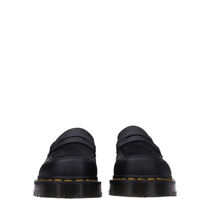 Front view of Dr. Martens Black Leather Slip-On Loafers with rubber sole and mid heels, featuring a square toe design.