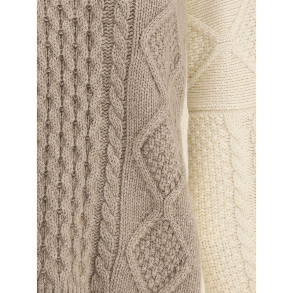 Close-up of Ella Cream Cashmere Cashmere Sweater's two-tone cable-knit texture, showing detail and craftsmanship.