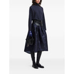 Model wearing dark blue Emporio Armani Sweaters Blue roll neck ribbed knit with long sleeves and straight hemline, styled with a black skirt.