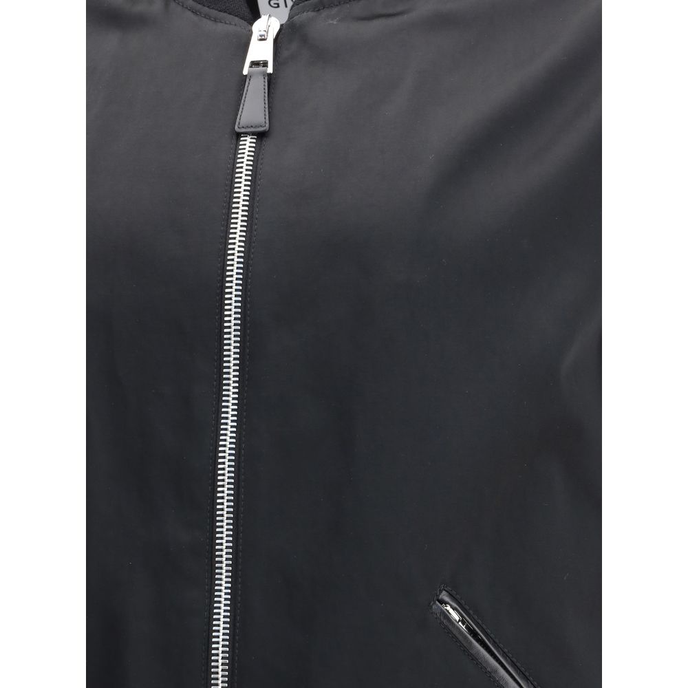 Close-up of Givenchy Black Cotton Bomber with satin body and leather detailing, featuring zipper closure.