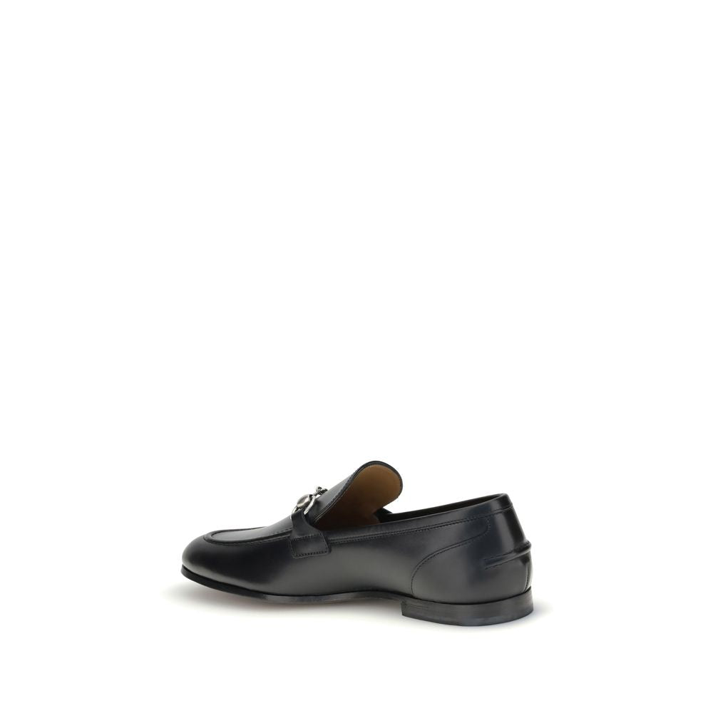Gucci Black Calf Leather Bos Taurus Slip-On Loafers with iconic Morsetto detail, side view showcasing elegant silhouette.