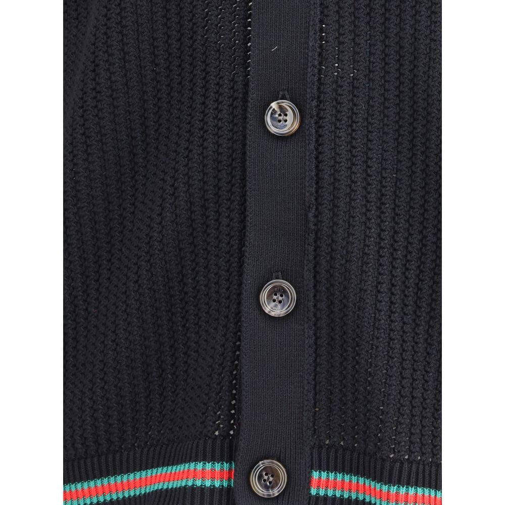 Close-up of Gucci Black Cotton Cardigan with button details, showcasing knit texture and ribbed hem for a refined look.