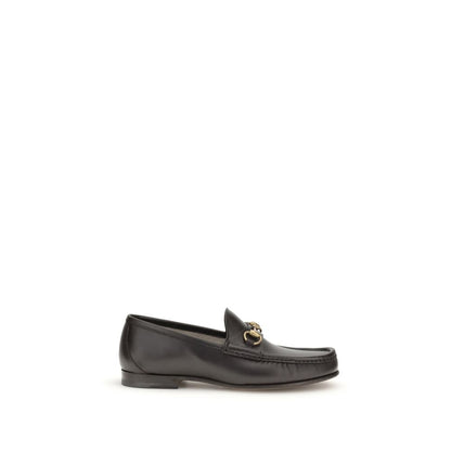Gucci Brown Calf Leather Bos Taurus Slip-On Loafers with Horsebit detail in dark brown leather, part of 1953 Collection, side view.