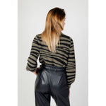 Back view of woman wearing Jacqueline De Yong Green Nylon Sweater with animal print, paired with black leather pants.
