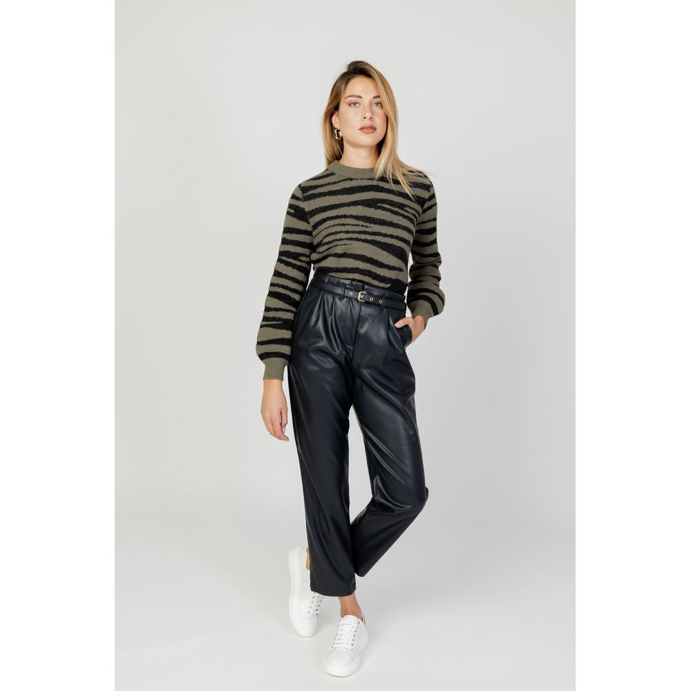 Model wearing Jacqueline De Yong Green Nylon Sweater with animal print, paired with black trousers and white sneakers, showcasing modern style.