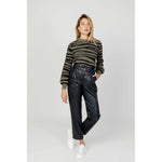 Model wearing Jacqueline De Yong Green Nylon Sweater with animal print, paired with black trousers and white sneakers, showcasing modern style.