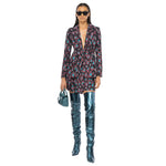 Model wearing floral blazer dress with blue thigh-high boots and sunglasses.