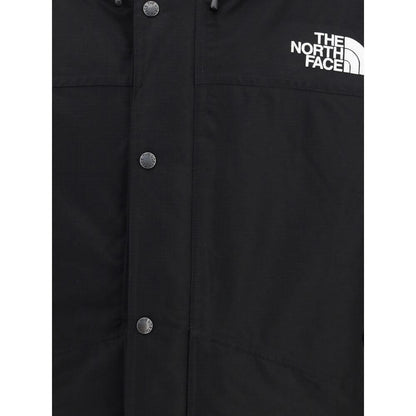 Close-up of The North Face Black Polyester Coat showcasing button detail and logo on chest.