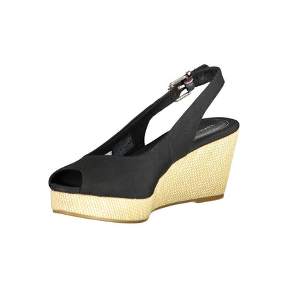Tommy Hilfiger Black Leather Women Sandal with ankle buckle on woven wedge heel, chic fashion accessory.