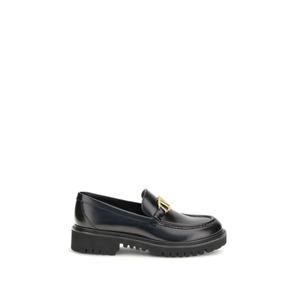 Valentino Garavani Black Leather Slip-On Loafers with VLogo detail and rubber lug sole.