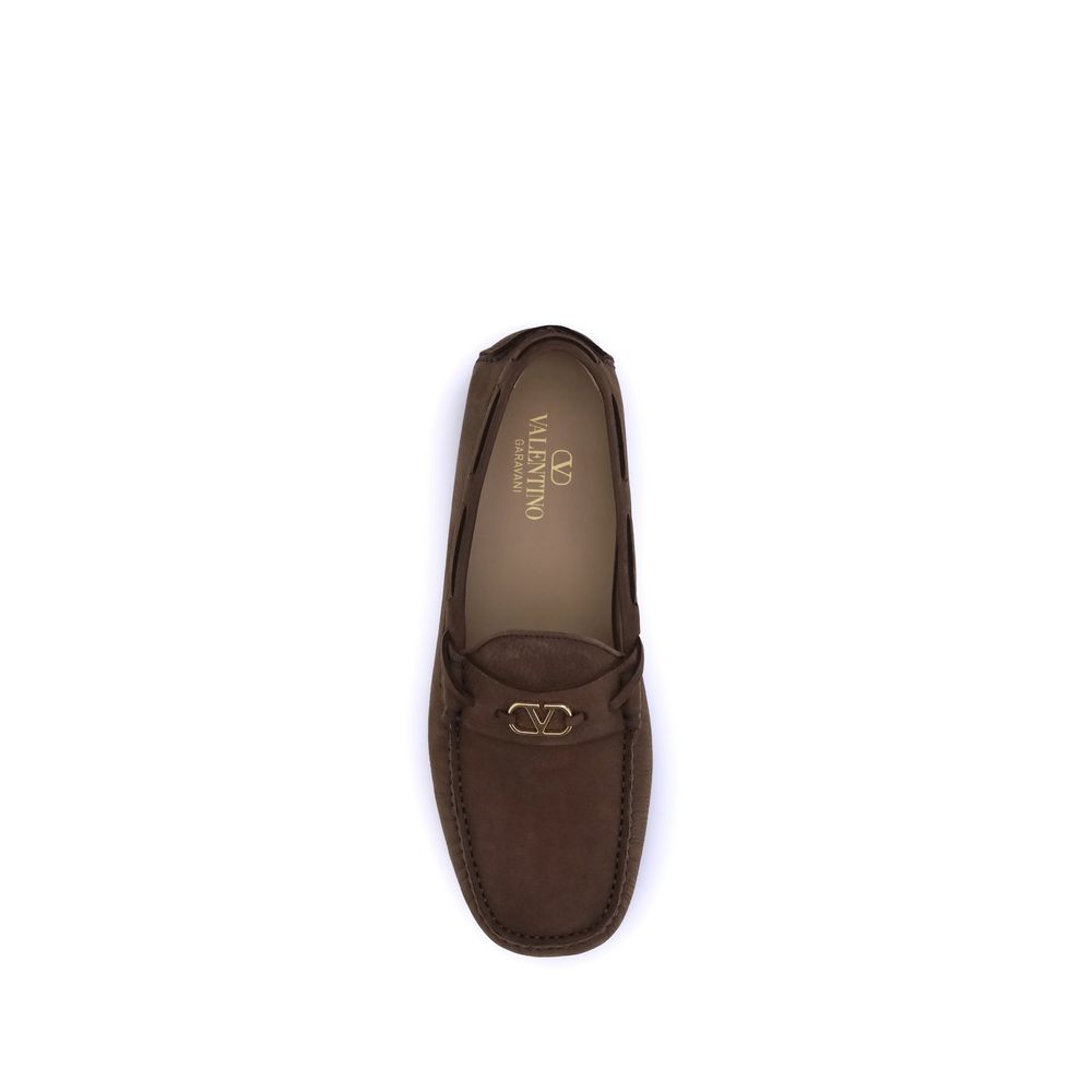 Valentino Garavani Brown Rubber Slip-On Loafers with VLogo plaque and notched sole for elegance and comfort.